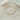 White Beaded Bracelet with small gold beads that is placed on a linen table.