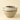 A handmade ceramic planter pot with a textured, speckled light gray and beige glaze, featuring a dark brown band of irregular speckles around the middle and small side handles, set against a solid cream background.