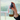 Mint Room Spray with a brown bottle and mint coloured label. A hand model is spraying the bottle against a misty background outside