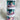Three-tiered cylindrical container with unicorn figurines on a fluffy white surface.  Sensory kit with playdoh.