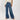 Woman wearing a white top and blue jeans on a white background