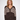 A woman modeling a brown and beige striped knit cardigan with front buttons, paired with dark brown pants, against a plain light gray studio background.