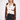 A woman modeling a cream and brown knit cardigan with black trim, paired with black jeans, against a plain white studio background.