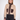 A woman modeling a cropped knit zip-front sweater in beige and dark brown, paired with dark jeans, against a plain light gray studio background.