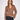 A woman modeling a cropped, long-sleeve knit cardigan in a warm brown color with dark buttons, paired with dark blue jeans, against a plain white studio background.