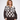 A woman modeling a dark brown and cream crochet-knit sweater with a checkerboard pattern and light blue trim, paired with dark brown trousers, against a plain white studio background.